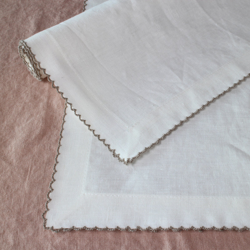 Crochet-edged napkin sets.